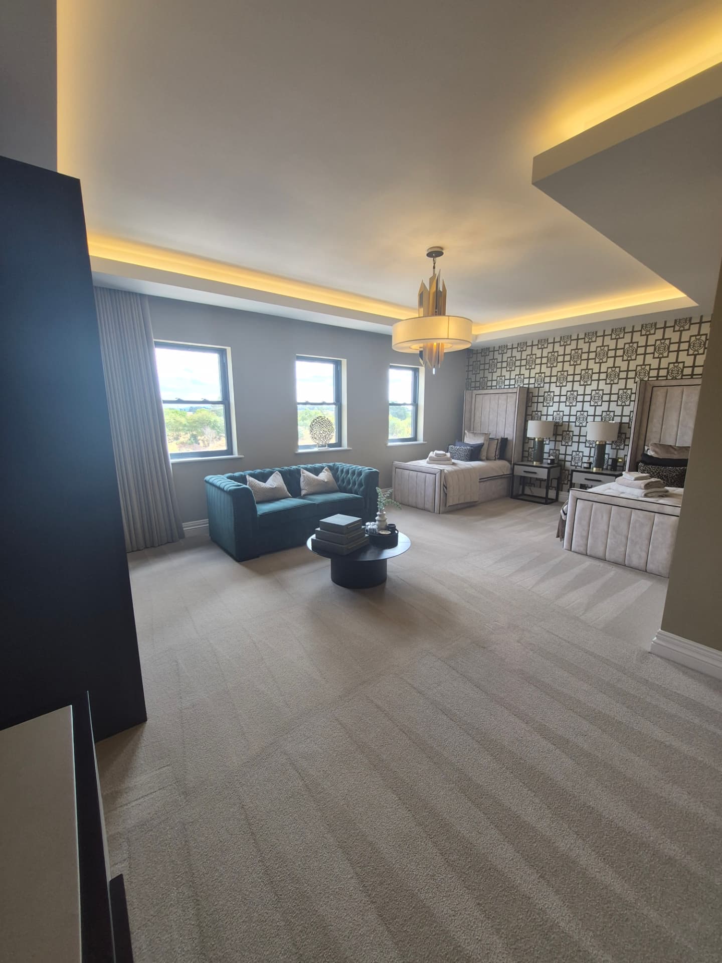 Large bedroom suite with freshly vacuumed carpet and dressed beds