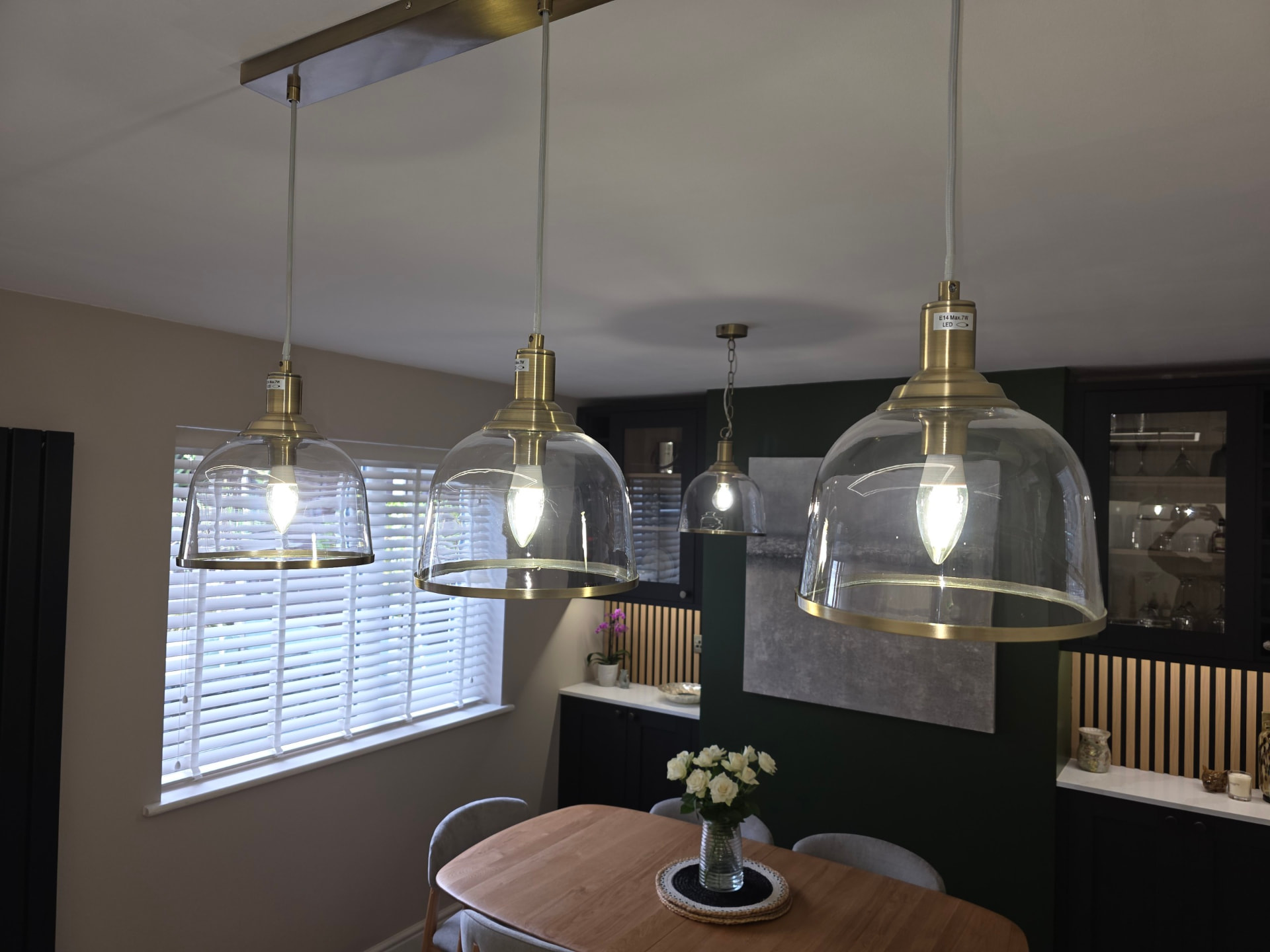 Dusted glass pendant lights above a dining table